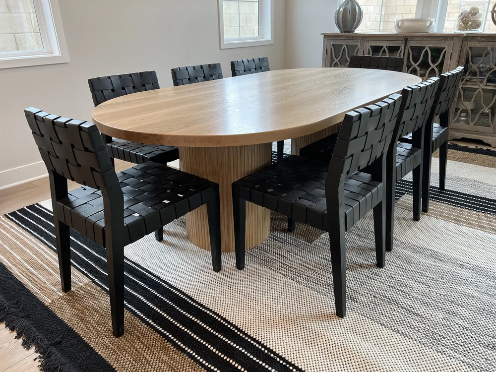 oval table with black wicker chairs